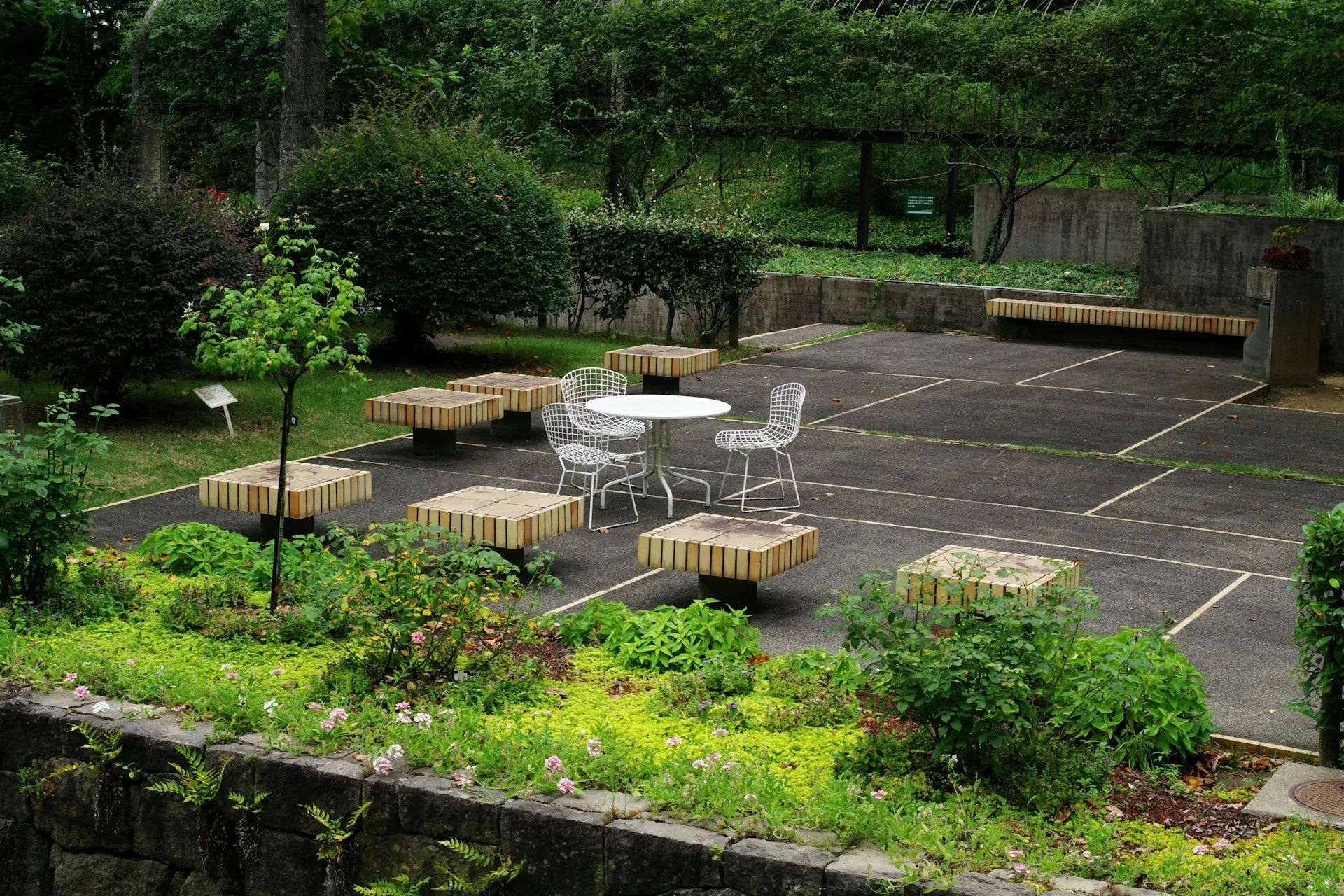 Stylish rooftop patio with table and chairs surrounded by lush greenery