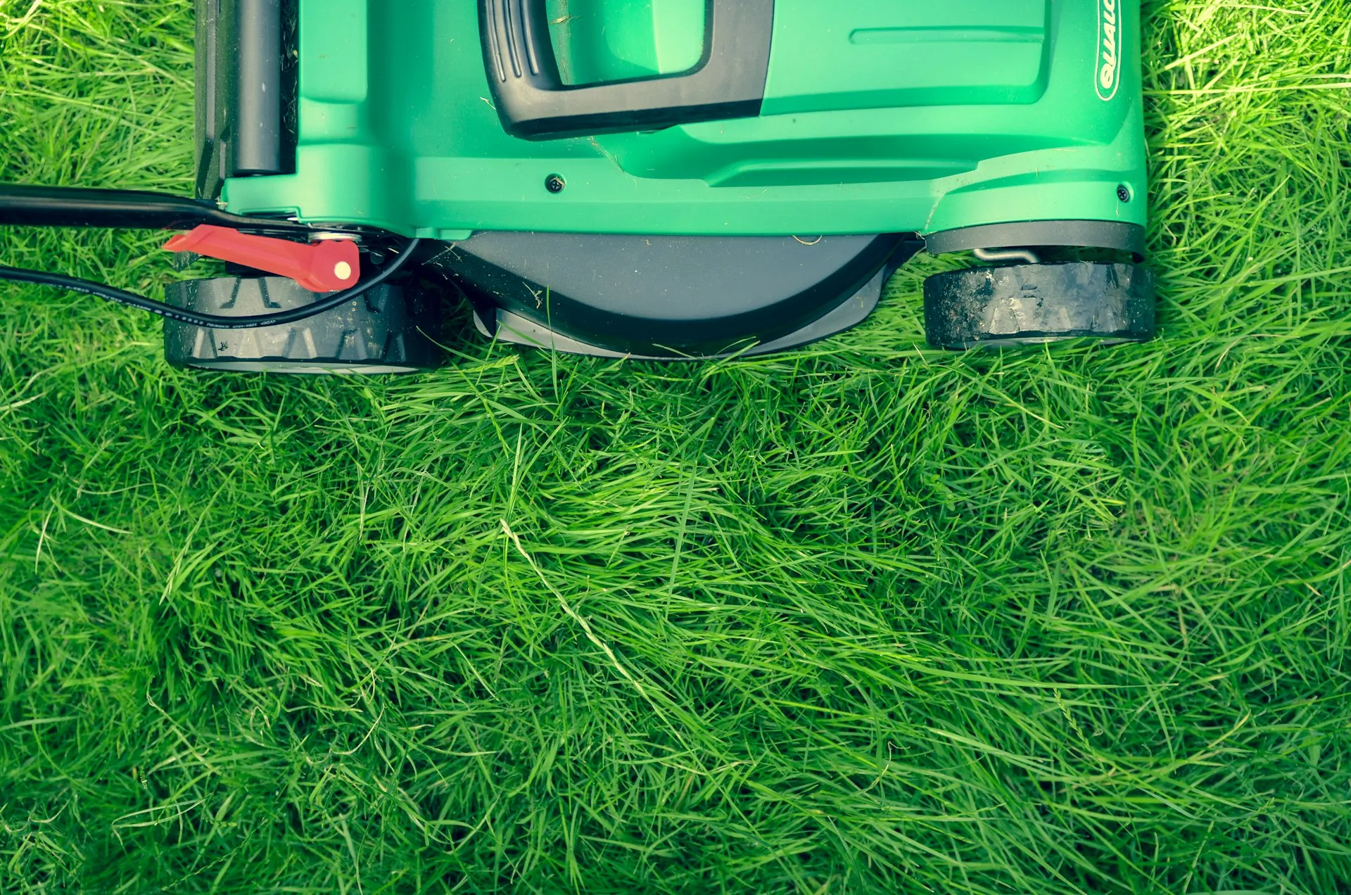 Professional lawn mower on perfectly maintained green grass